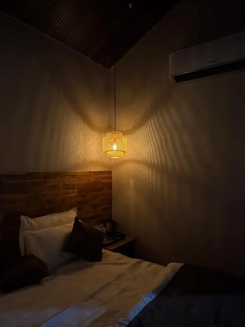 Deluxe room with wood feature wall and rustic lounge chairs